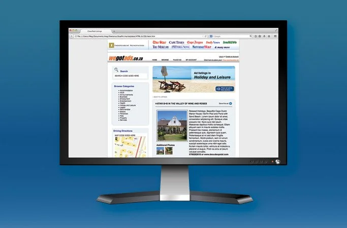 A computer monitor displaying a website with travel and leisure content, including images of a beach scene with lounge chairs and an umbrella, and a white lighthouse.