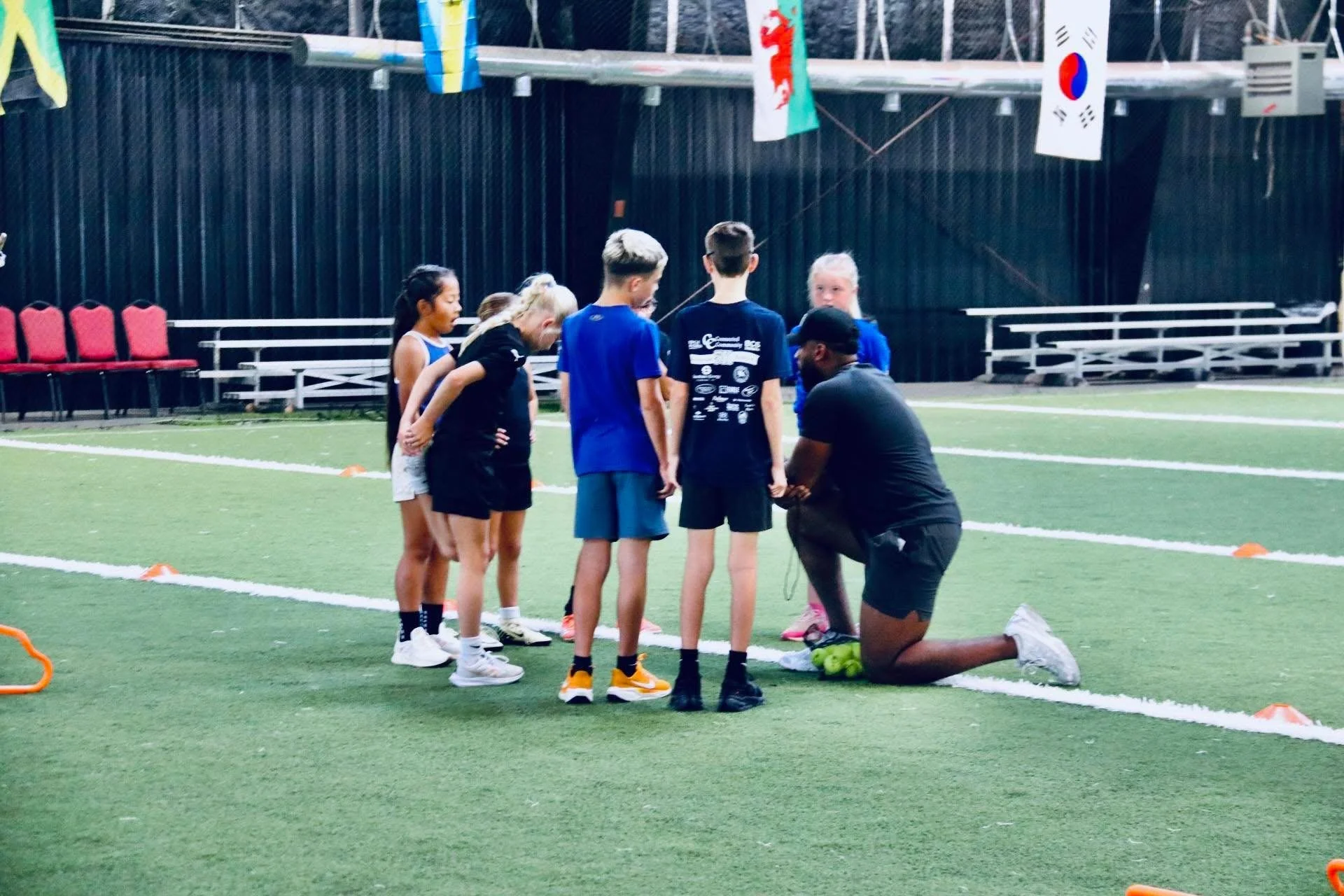 Young athletes gather with their coach during a 7th Period clinic.
