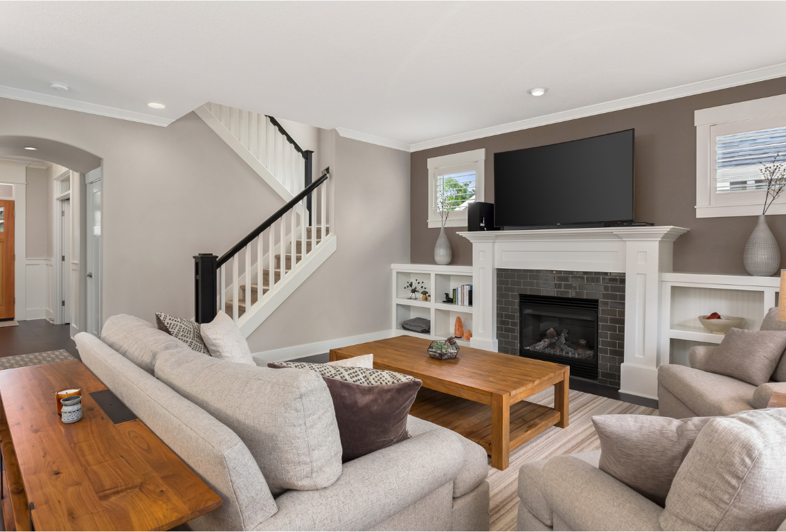 Living room renovation with fireplace mantle, windows, and new stair banister.
