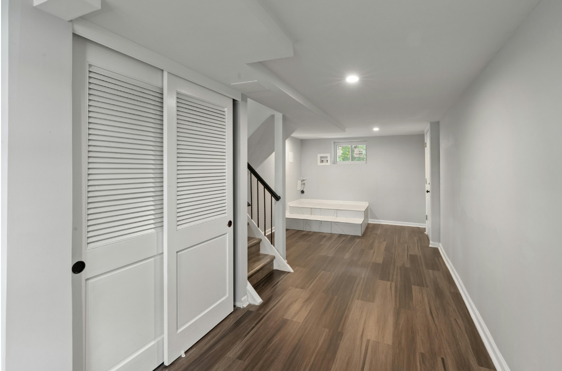 New basement renovation with new flooring and closet doors.