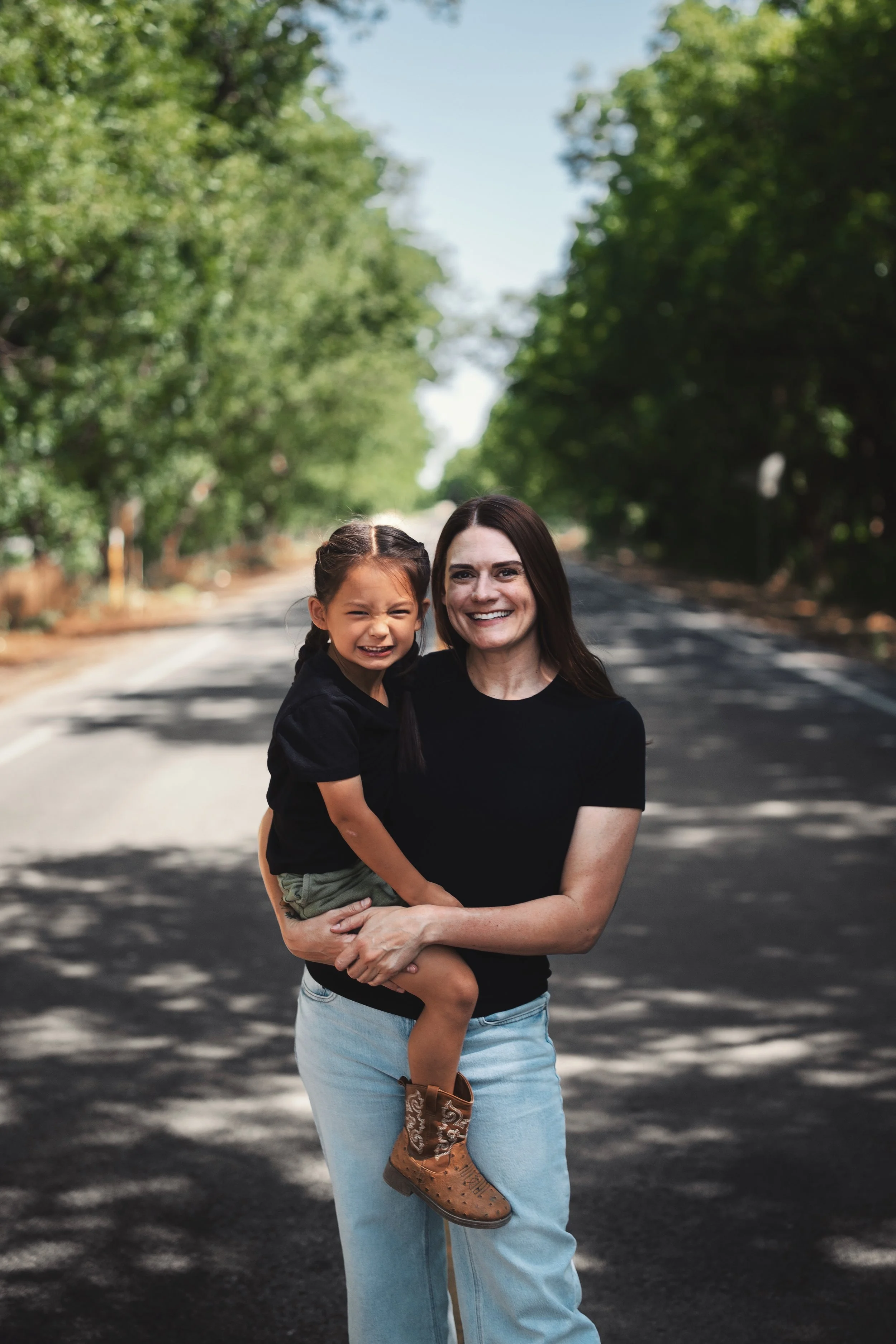 Photo of Amy and her son on a road by a pecan farm in Mesilla.