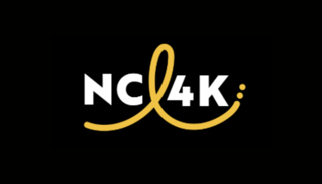 Logo with the text 'NC4K' in white, featuring a yellow heart shape integrated into the letter 'K' and a yellow semicolon at the end, on a black background.