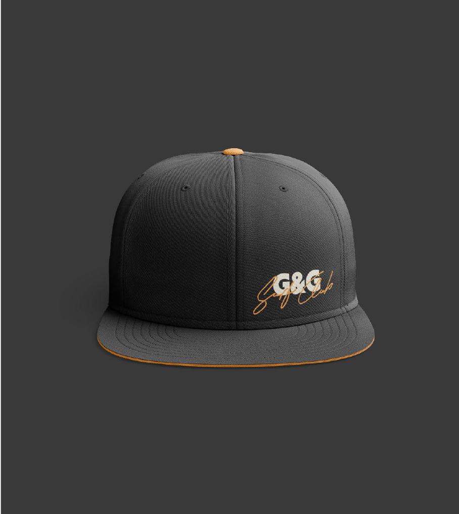 If the merch is this cool, imagine the flavors and vibe. A black crew baseball cap displaying the G&G Surf Club logo in white and orange cursive on the front.