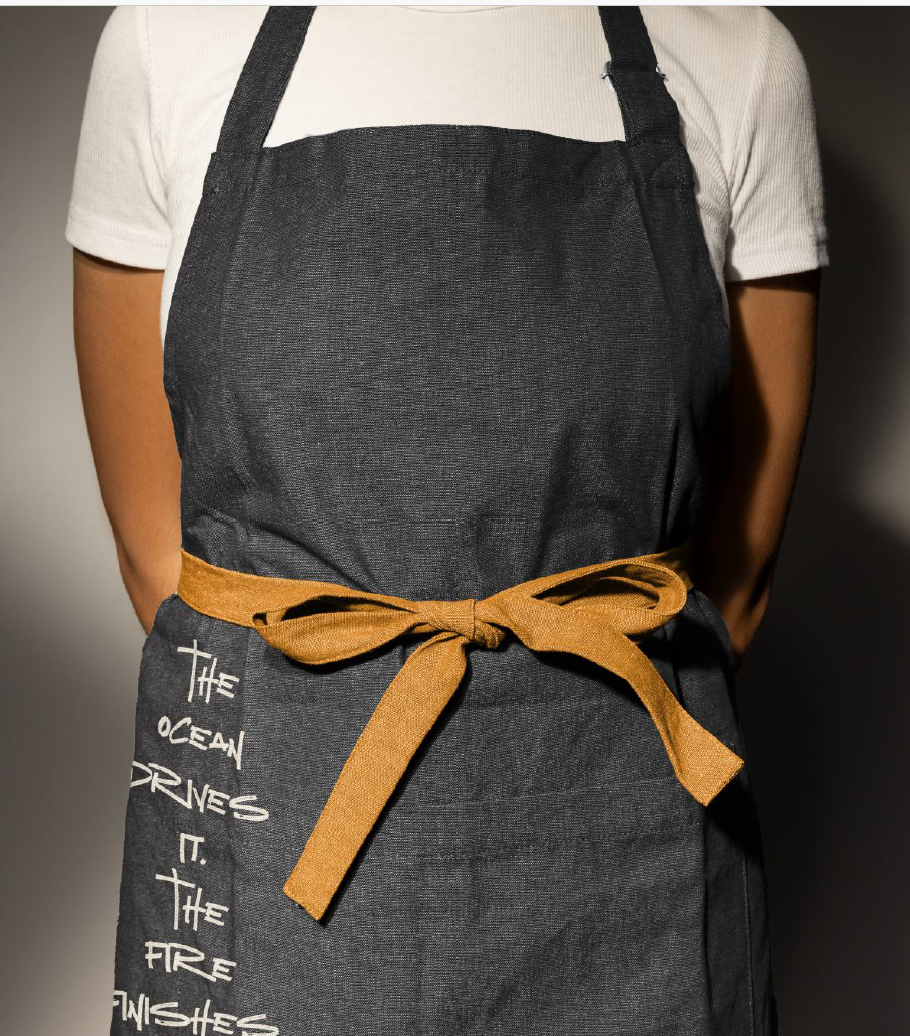 Spiffy G&G Surf Club team member wearing a white T-shirt and custom apron saying a phrase capturing the vibe of GGSC.