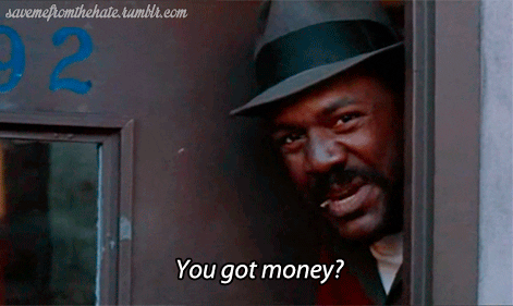 A man with a fedora hat peeking out from behind a door frame, asking 'You got money?' in a scene from a movie or TV show.