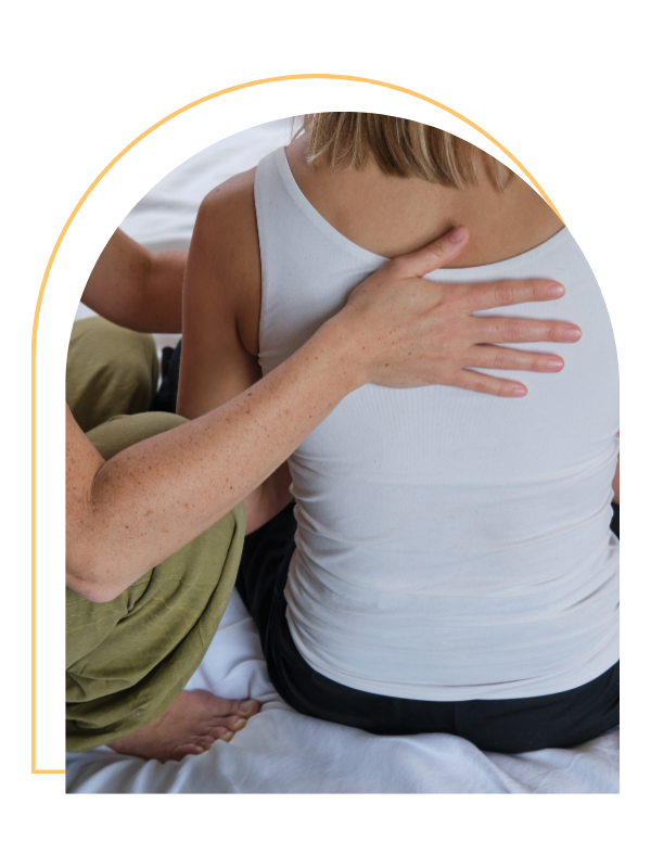 A person providing CPR or first aid to another person, pressing on their chest.