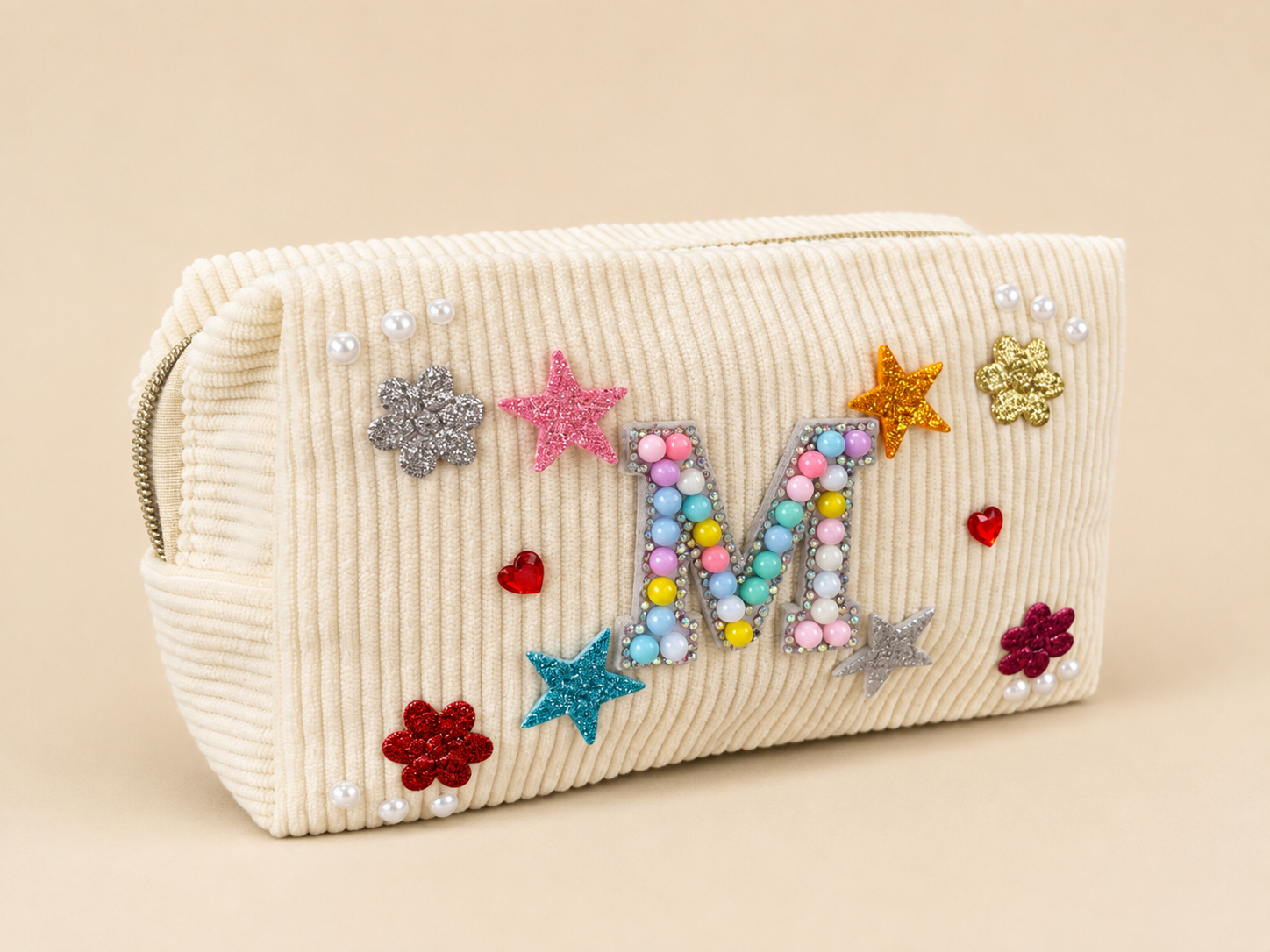 Cream-colored textured clutch purse decorated with colorful beads, glittery stars, flowers, pearls, and small heart embellishments.