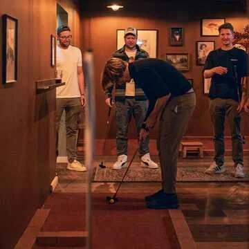 A group playing mini golf together