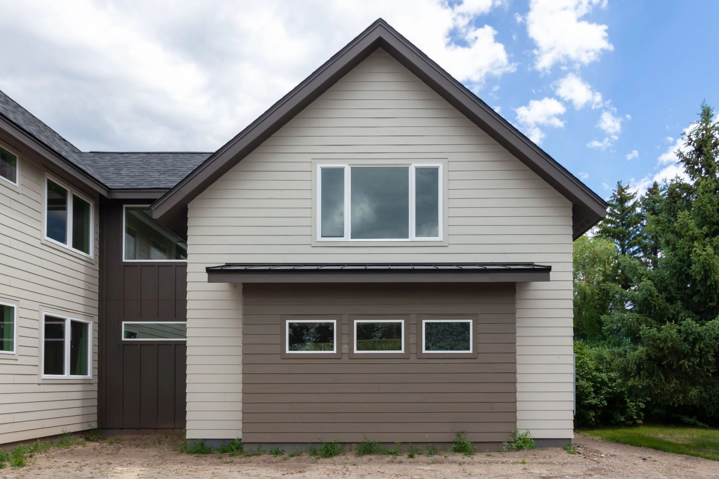 A 2-story, 3,500-sf residence with vaulted Living Room and Upper Level Loft in addition to a Gym and Office area above the Garage just north of Bozeman.
