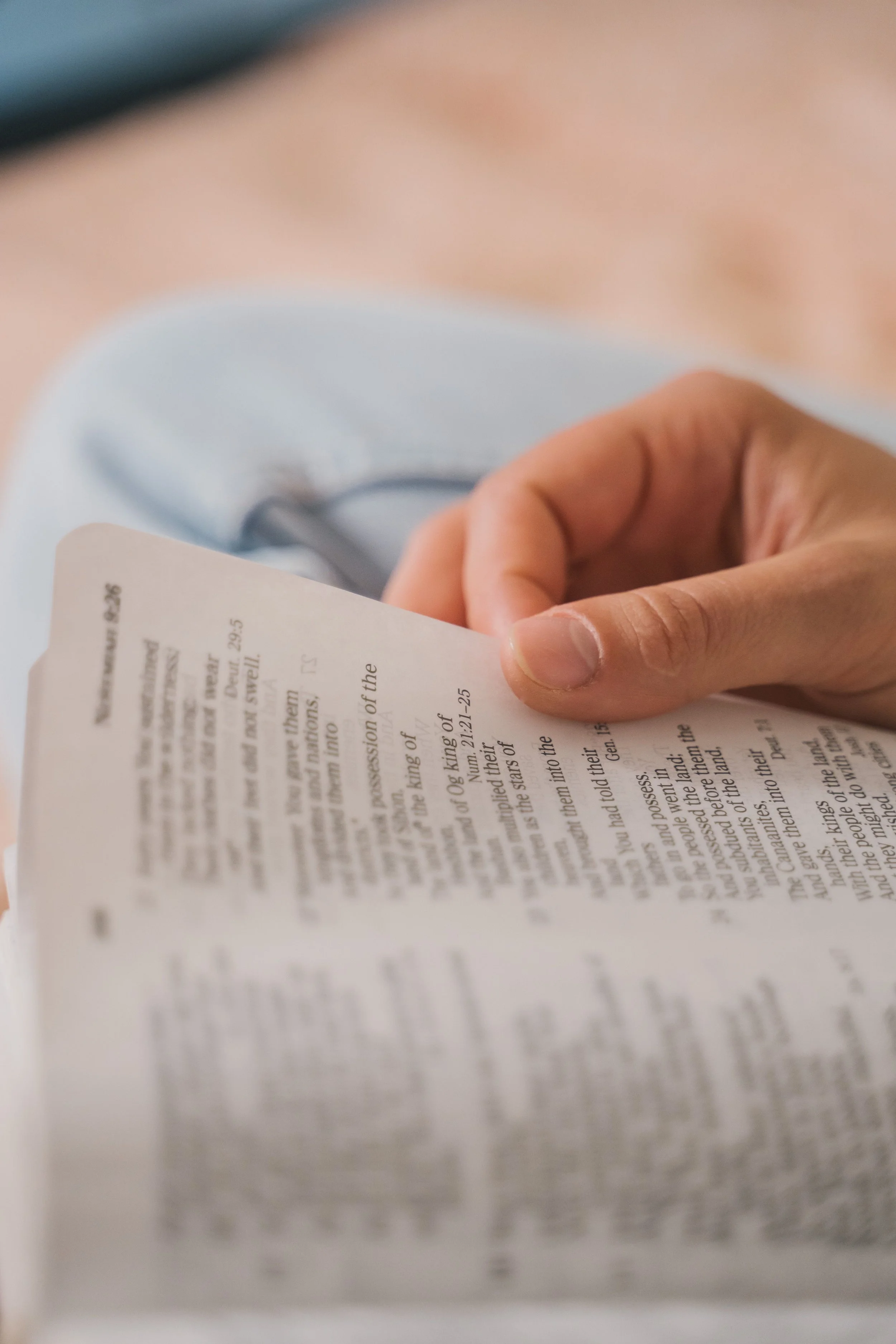 Quiet moment of reading scripture with a hand resting on the page