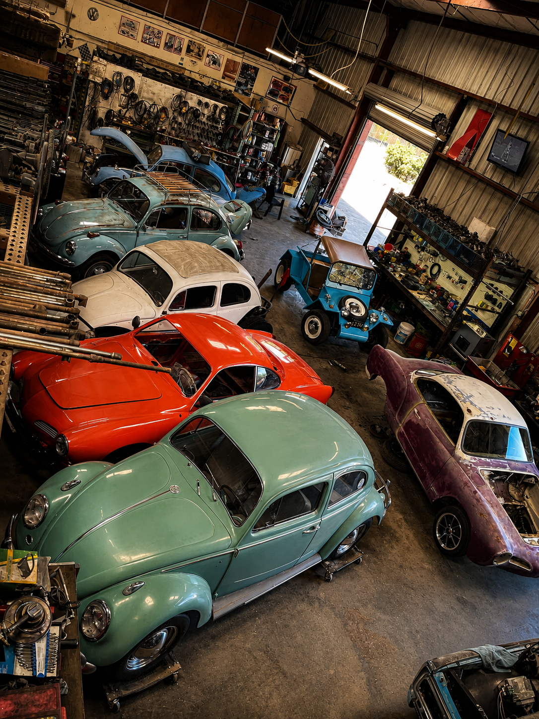 Inside the BenBuilt Customs workshop with classic Volkswagen Beetles, Karmann Ghias, and restoration projects in progress.