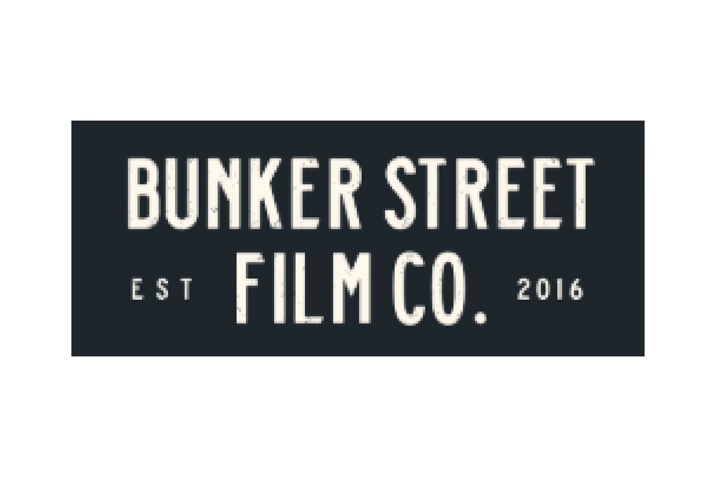 Close-up of a black rectangular sign with white text displaying 'BUNKER STREET FILM CO.' established in 2016.
