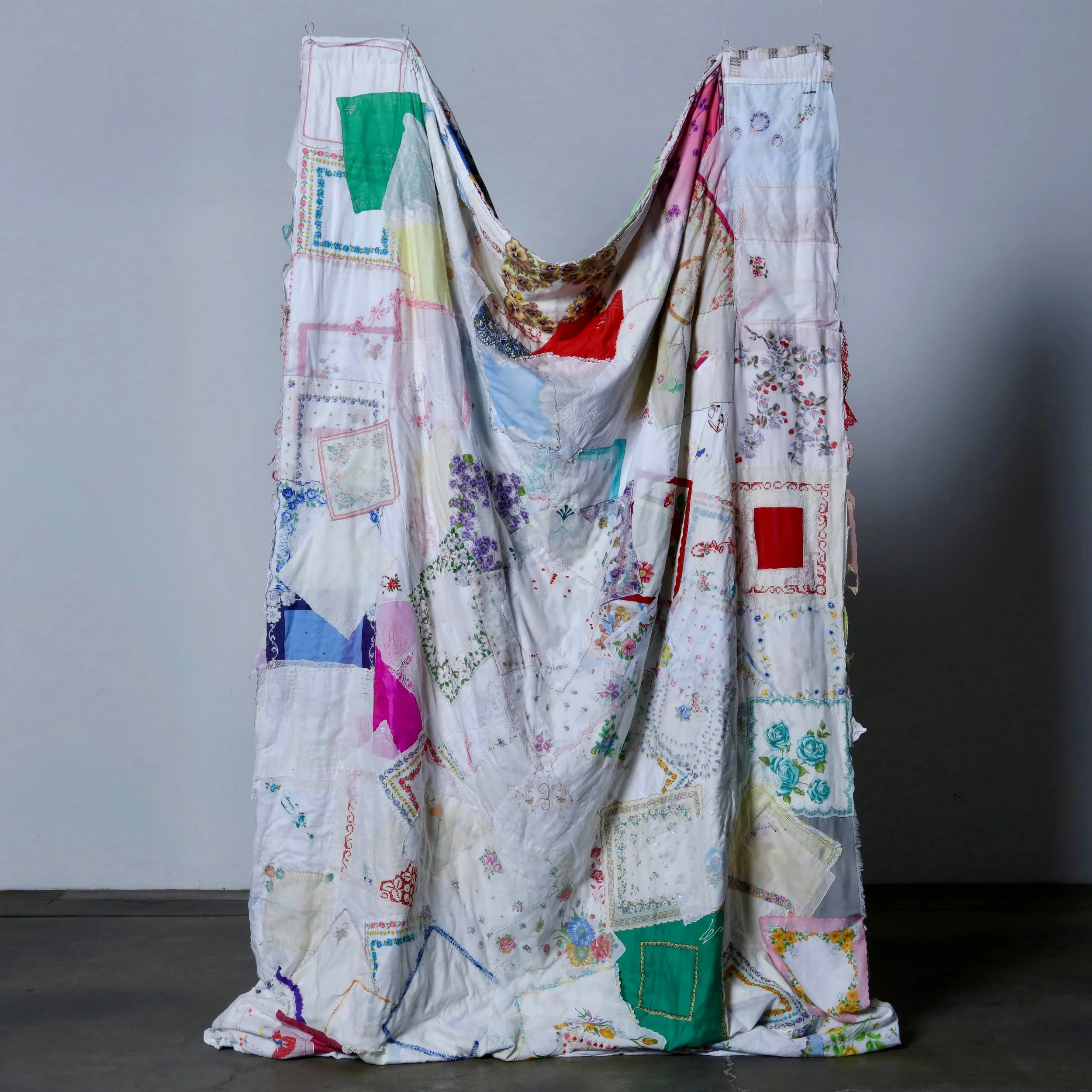 What Remains Hidden, 2026, reverse side,
vintage handkerchiefs, thread, and found textiles, installation view