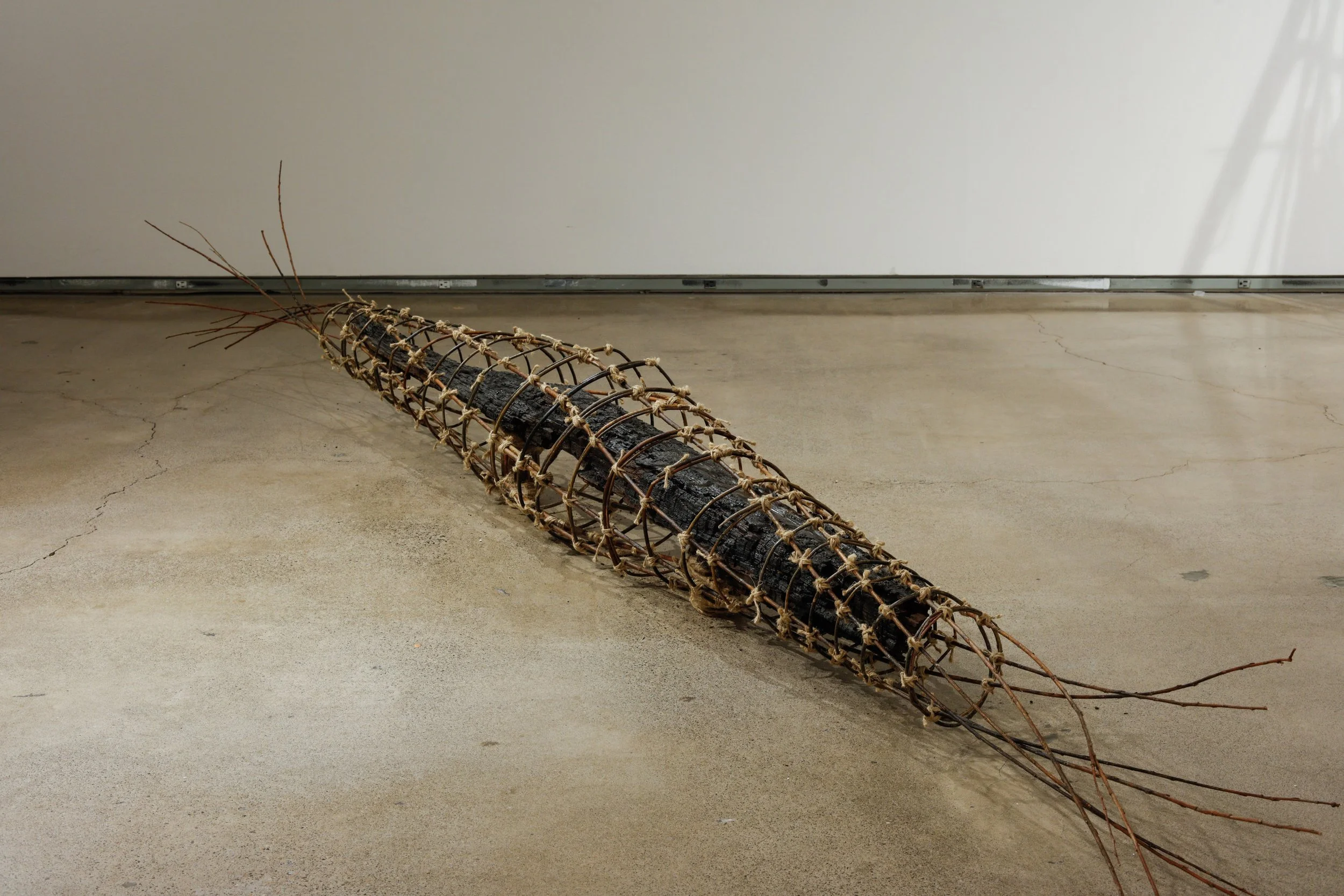 Embrace #2, 2023, charred redwood, willow, and jute, 120"x10"D