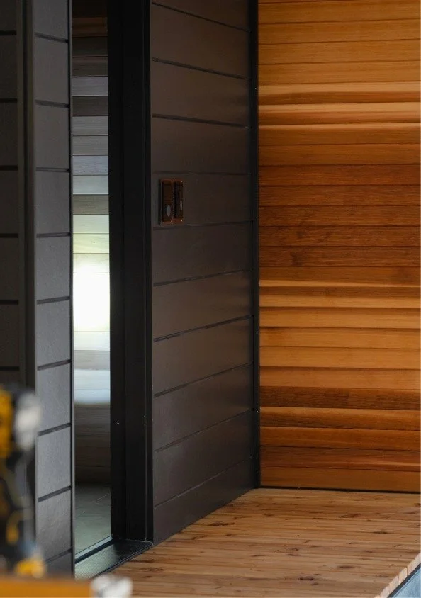 Close-up of a sliding door frame with wooden paneling inside a room.