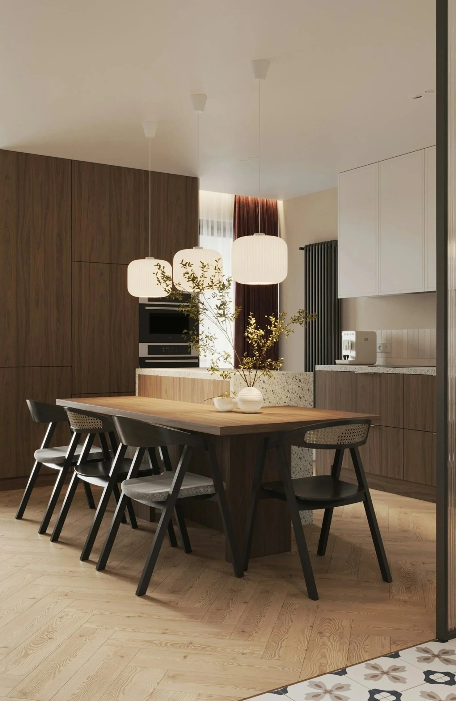 Modern dining area with wooden dining table and black chairs, pendant lights, and decorative plants. Open kitchen with cabinetry and appliances, tall radiator, and window with curtains.
