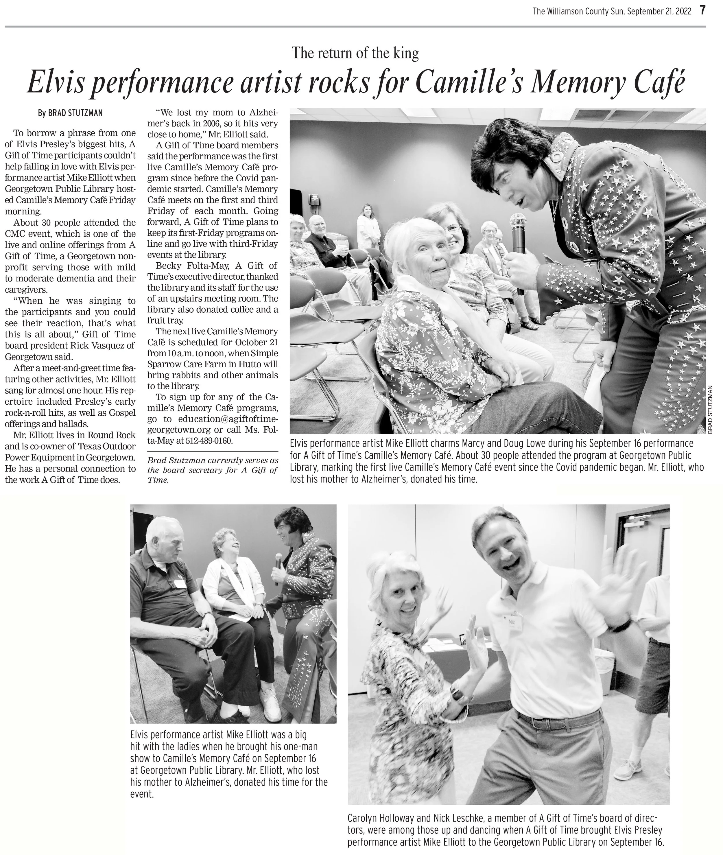 Elvis Presley tribute performer Mike Elliott sings to an audience in a library while a seated elderly woman looks up at him, with other people sitting and standing in the background.
