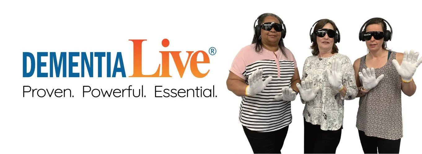 Three women wearing blackout glasses, white gloves, and headsets, standing together in a promotional photo for Dementia Live, with the tagline 'Proven. Powerful. Essential.'.
