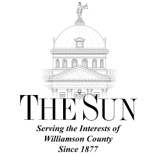 Illustration of a domed government building with a statue on top, with text reading "The Sun" and "Serving the Interests of Williamson County Since 1877."