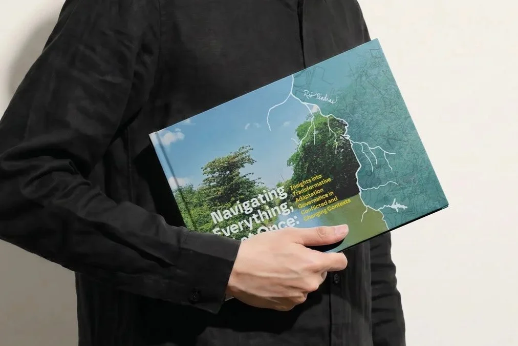 Person carrying a mockup of the Navigating Everything book under their arm.