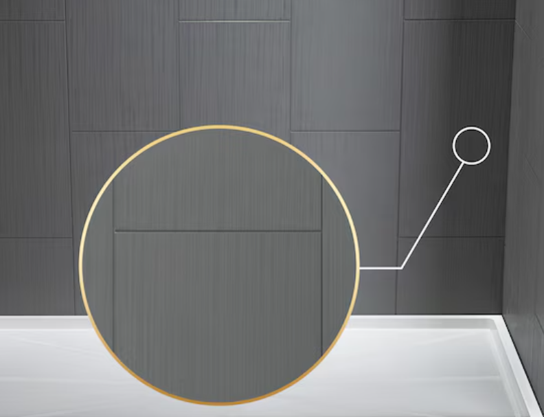 Close-up of a modern, dark grey, textured wall with a circular mirror or light fixture with a warm yellow glow.