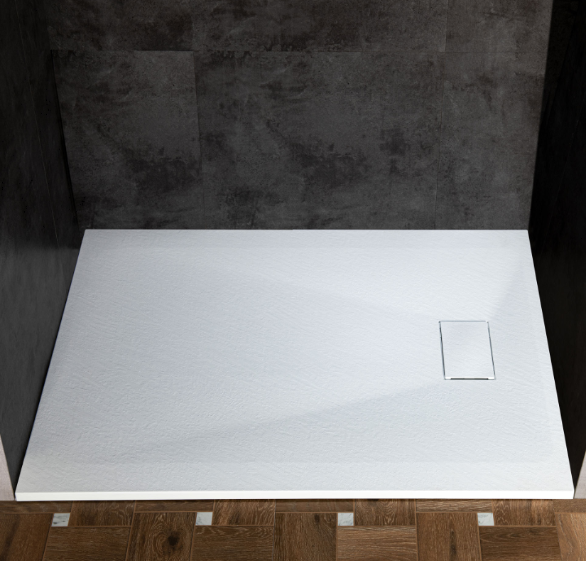 Empty shower base with dark tiled walls and wooden floor.