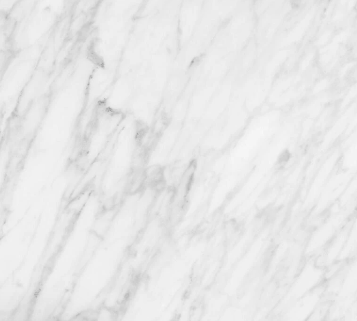 Close-up of a white marble surface with gray veining.