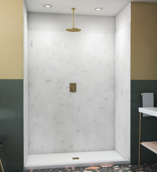 Empty walk-in shower with white marble walls, gold showerhead, and a white base.