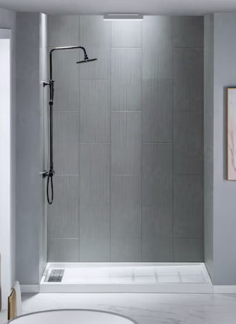 Modern walk-in shower with gray tiles, a black showerhead, and a handheld shower wand.