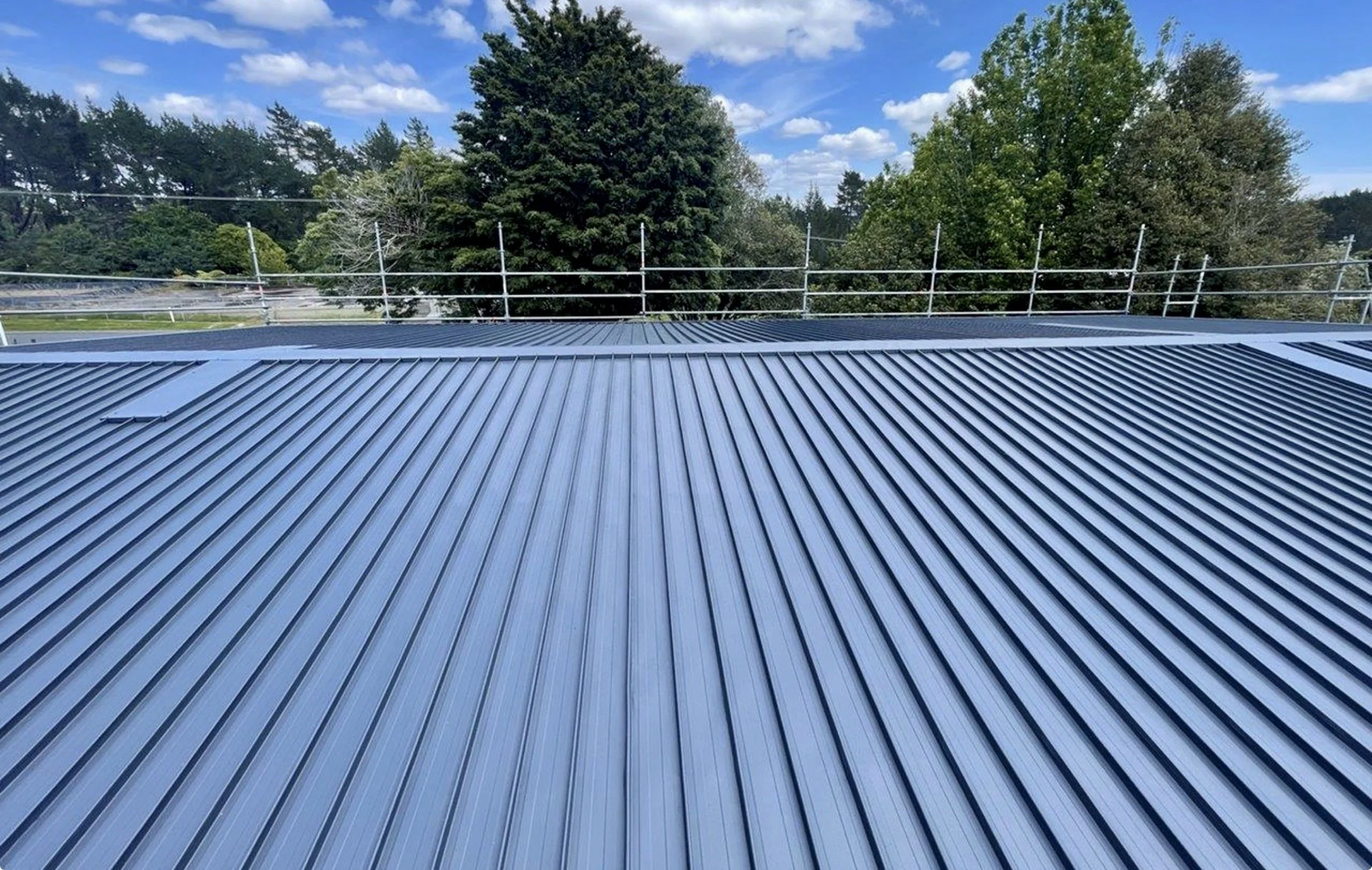 Detail of commercial roof repair with safety scaffolding in place, Bay of Plenty