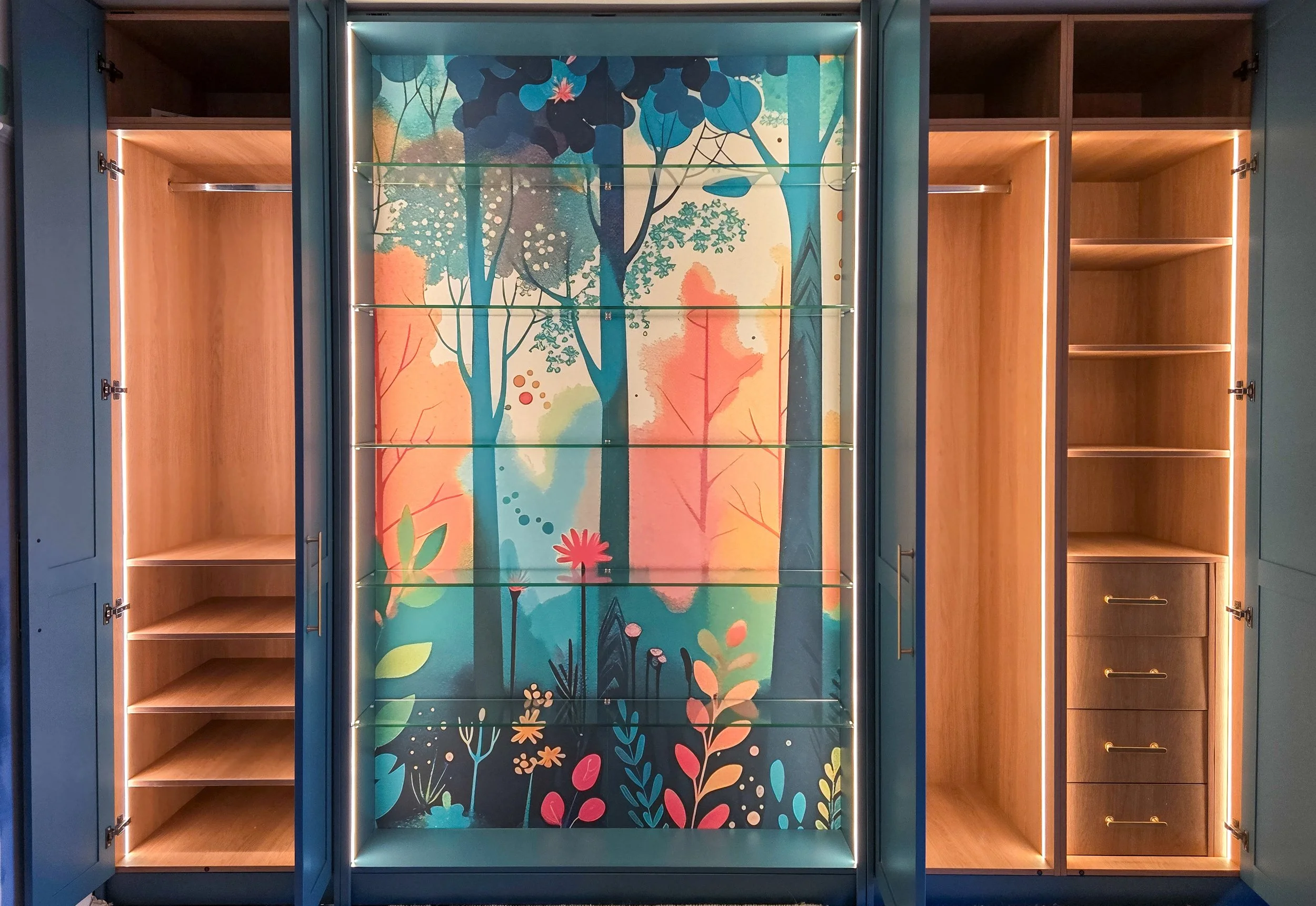 Empty display cabinet with glass shelves, featuring a colorful nature-themed mural with trees, leaves, and flowers in the background.