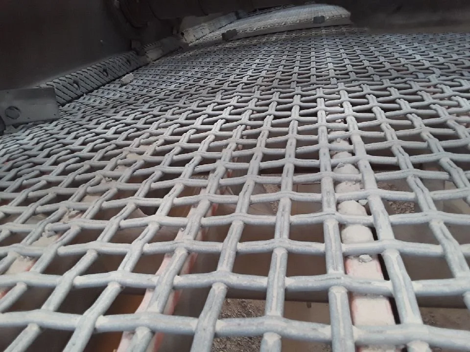 Close-up view of a metal grid or grate on a construction site, showing a pattern of intersecting bars.