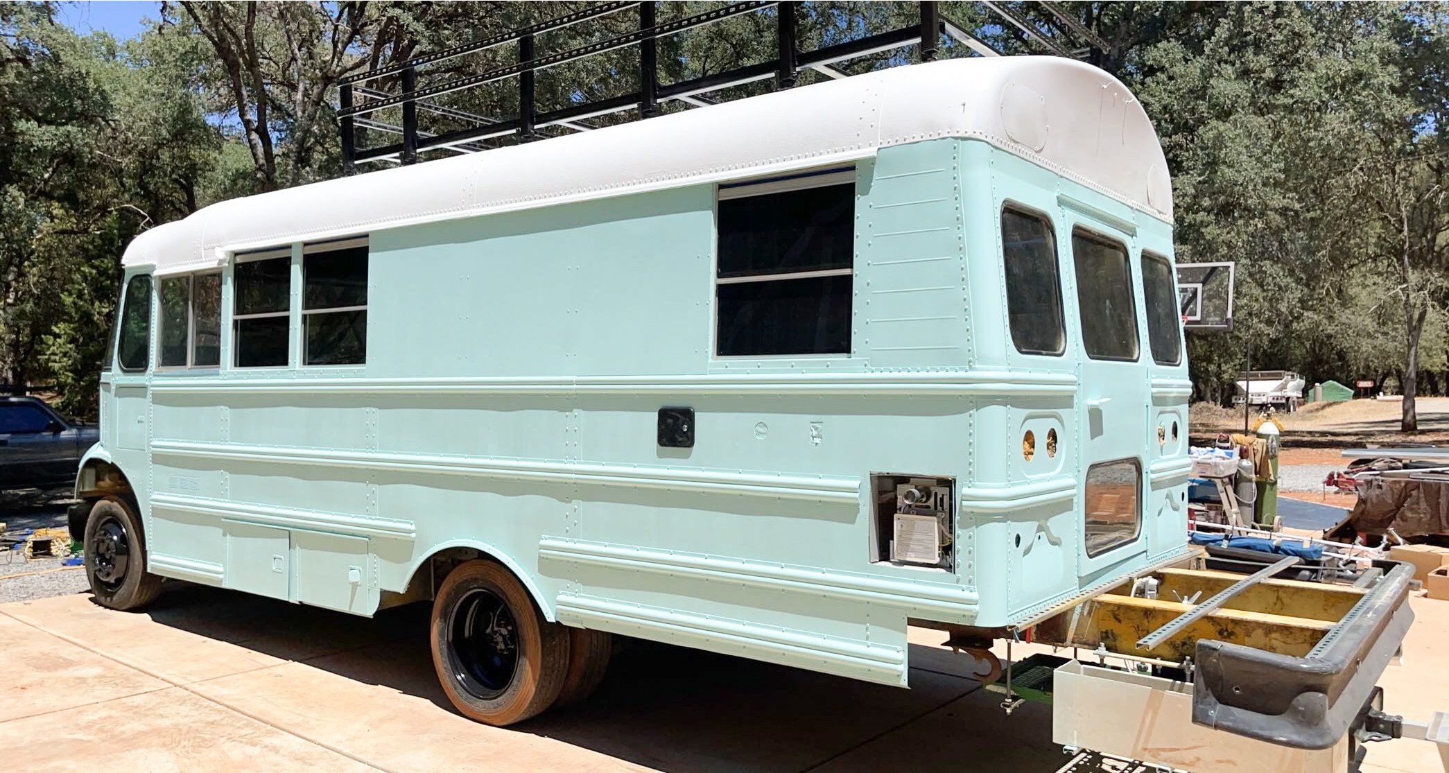 Completed exterior painting of a school bus with fresh professional finish.
