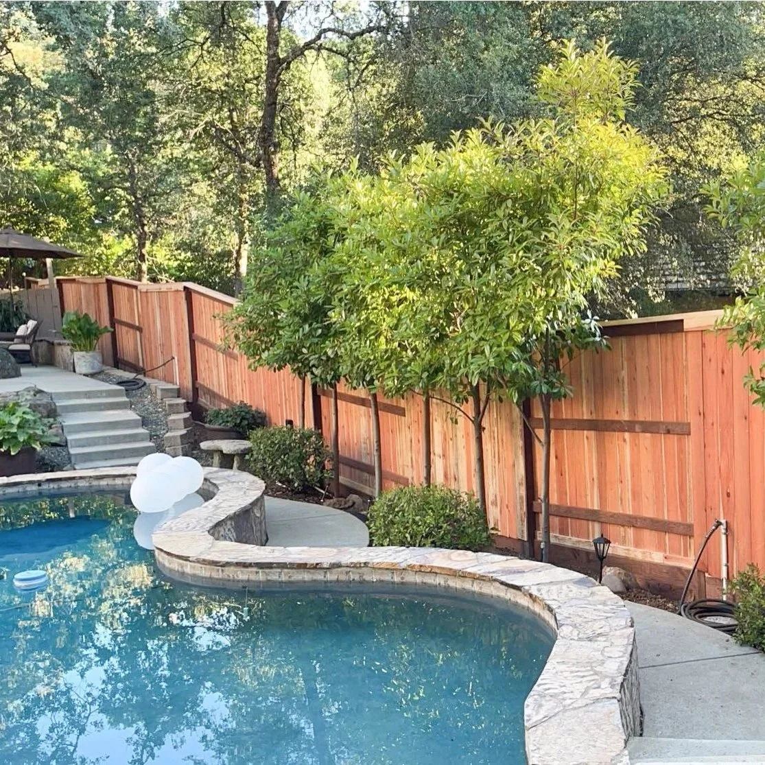 Completed redwood fence installation in a residential backyard.