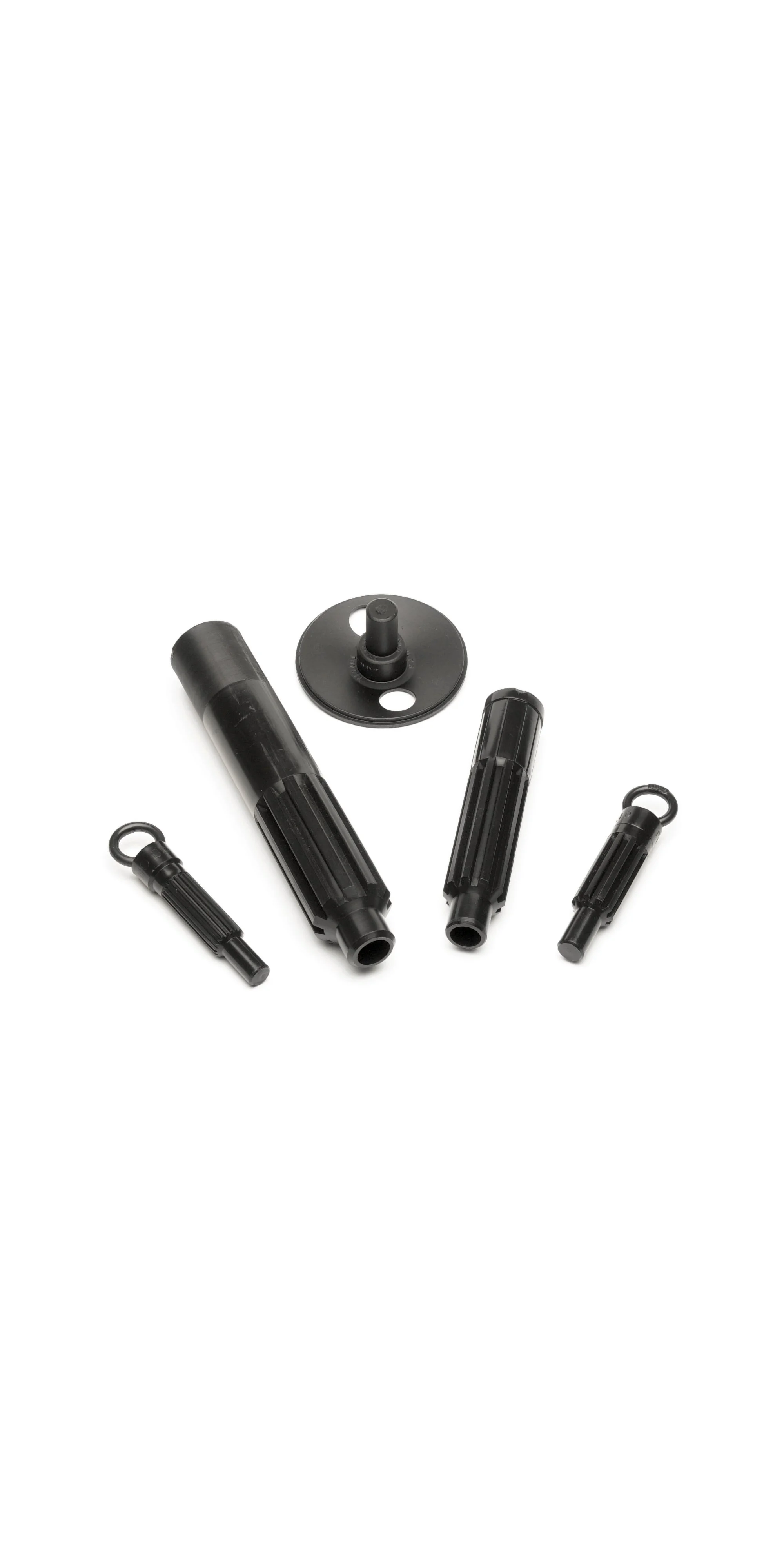 Set of black plastic repair pens and dot applicators on white background.