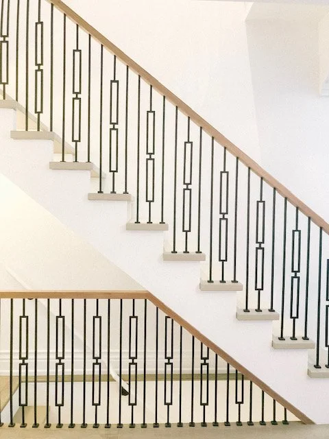 Modern stairs with wooden handrails and metal spindles in Burlington Ontario