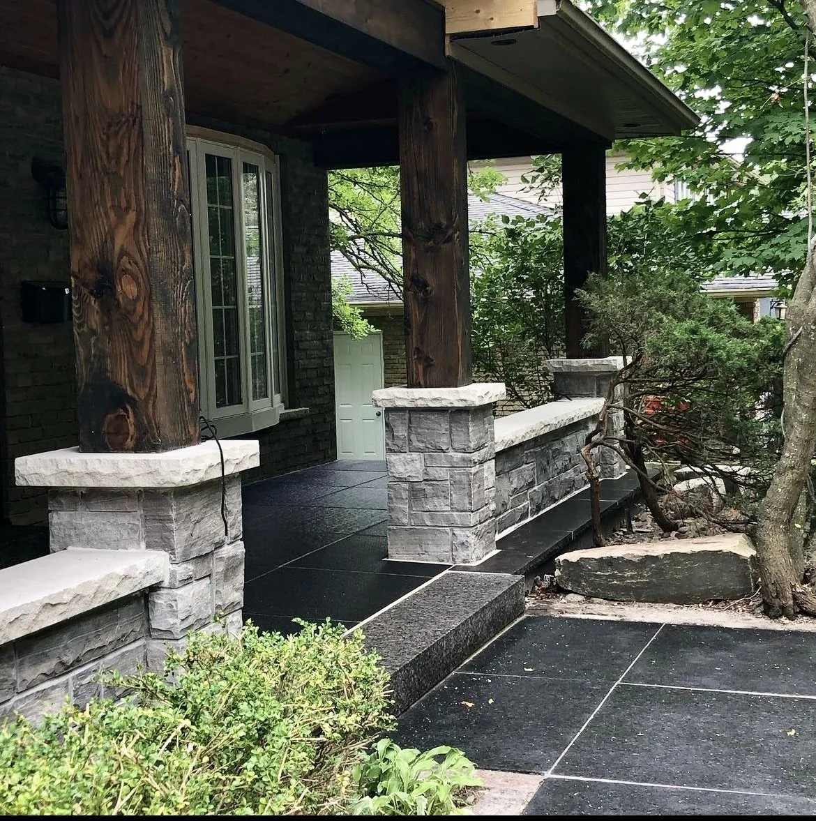 stone front porch with wooden columns and cedar lined ceiling in Oakville Ontario