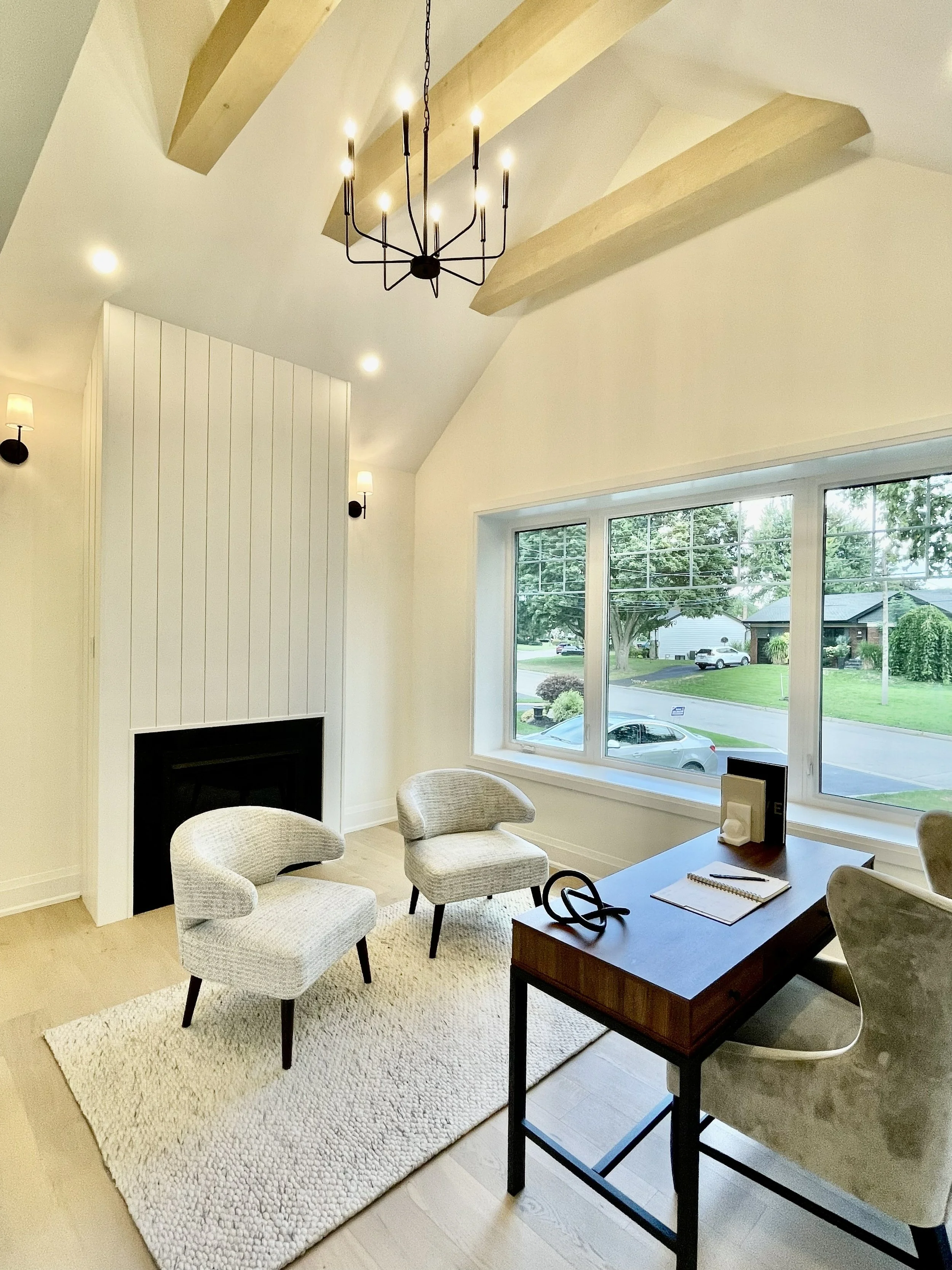 Modern renovation with wooden beams and wooden fireplace feature