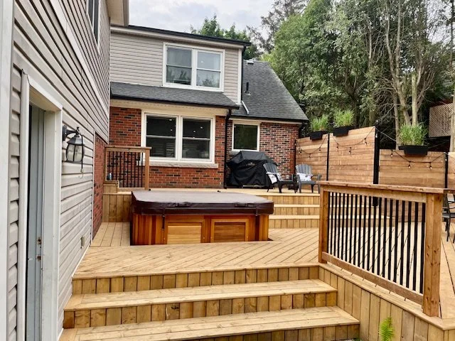 multi-level cedar deck with privacy walls and built-in hot tub in Burlington Ontario, including lighting