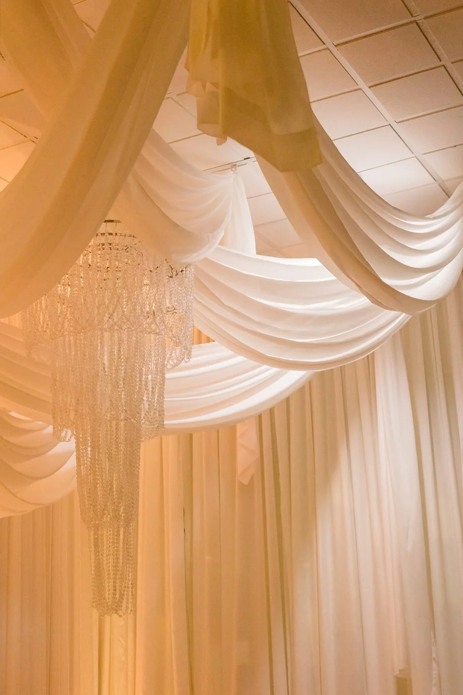 Swagged ceiling drapery canopy around a crystal chandelier at a London Ontario wedding reception
