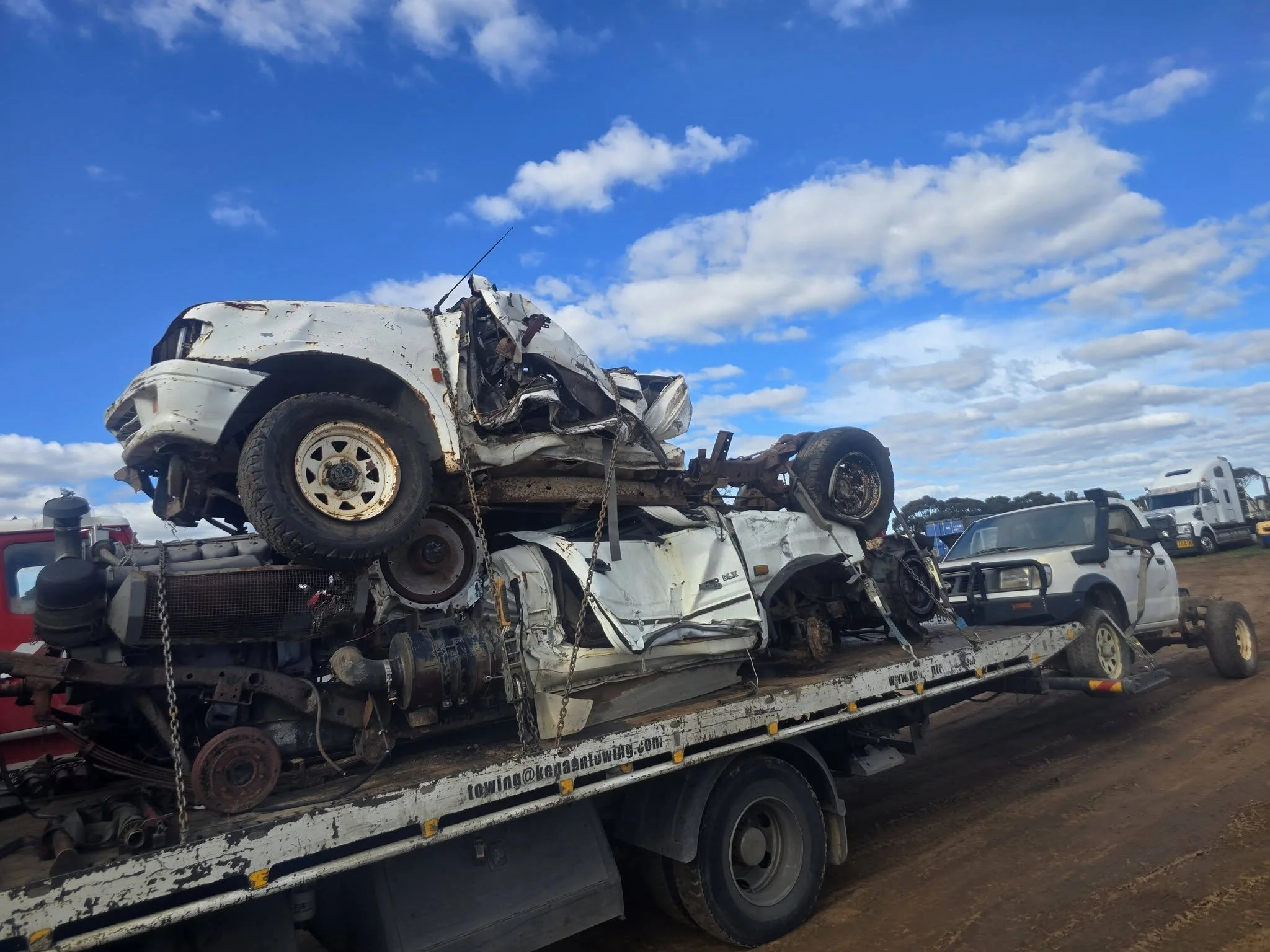 Kenaan Towing, carrying a heavily damaged vehicles