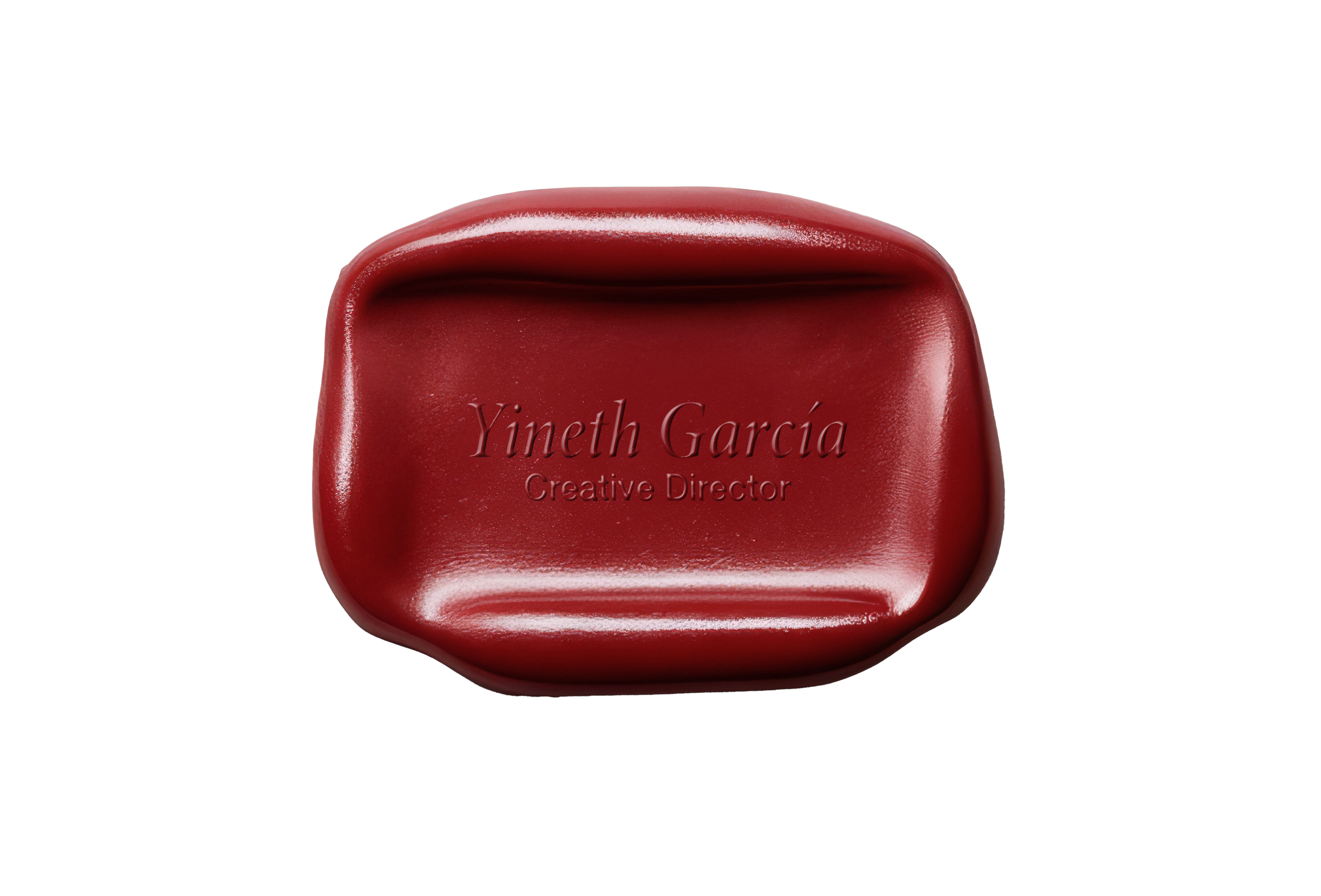 Close-up of a red wax seal with engraved text that reads 'Yineth García Creative Director' on a yellow background.