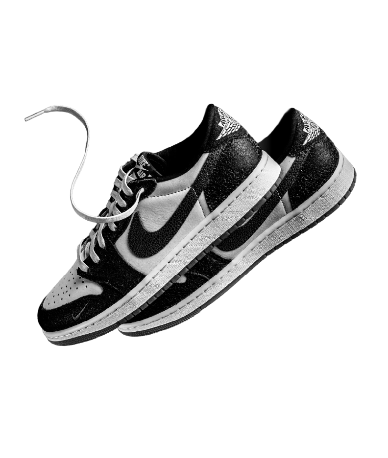 Black and white Nike sneakers against a black background.