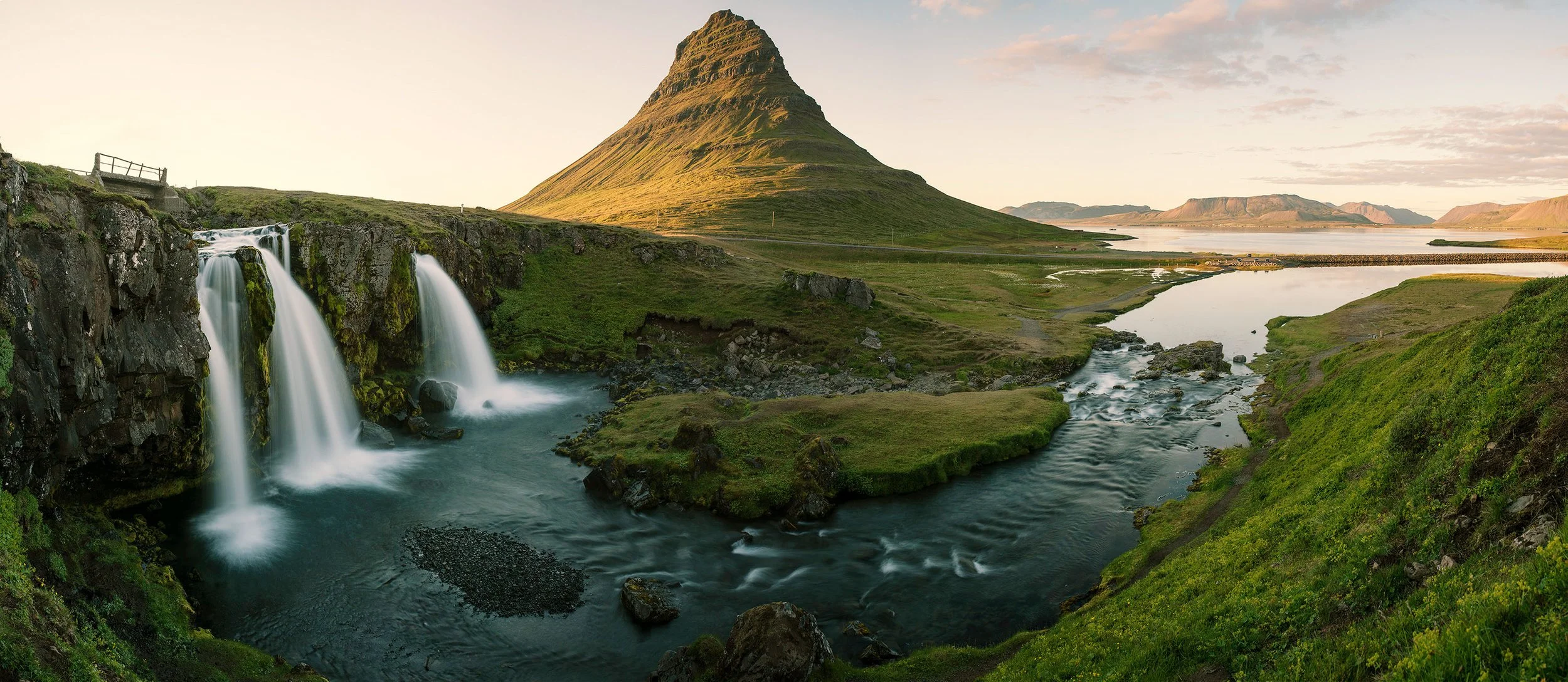 Fine art landscape photograph of Kirkjufell and its foreground waterfall, capturing the iconic Icelandic scene in calm evening light.