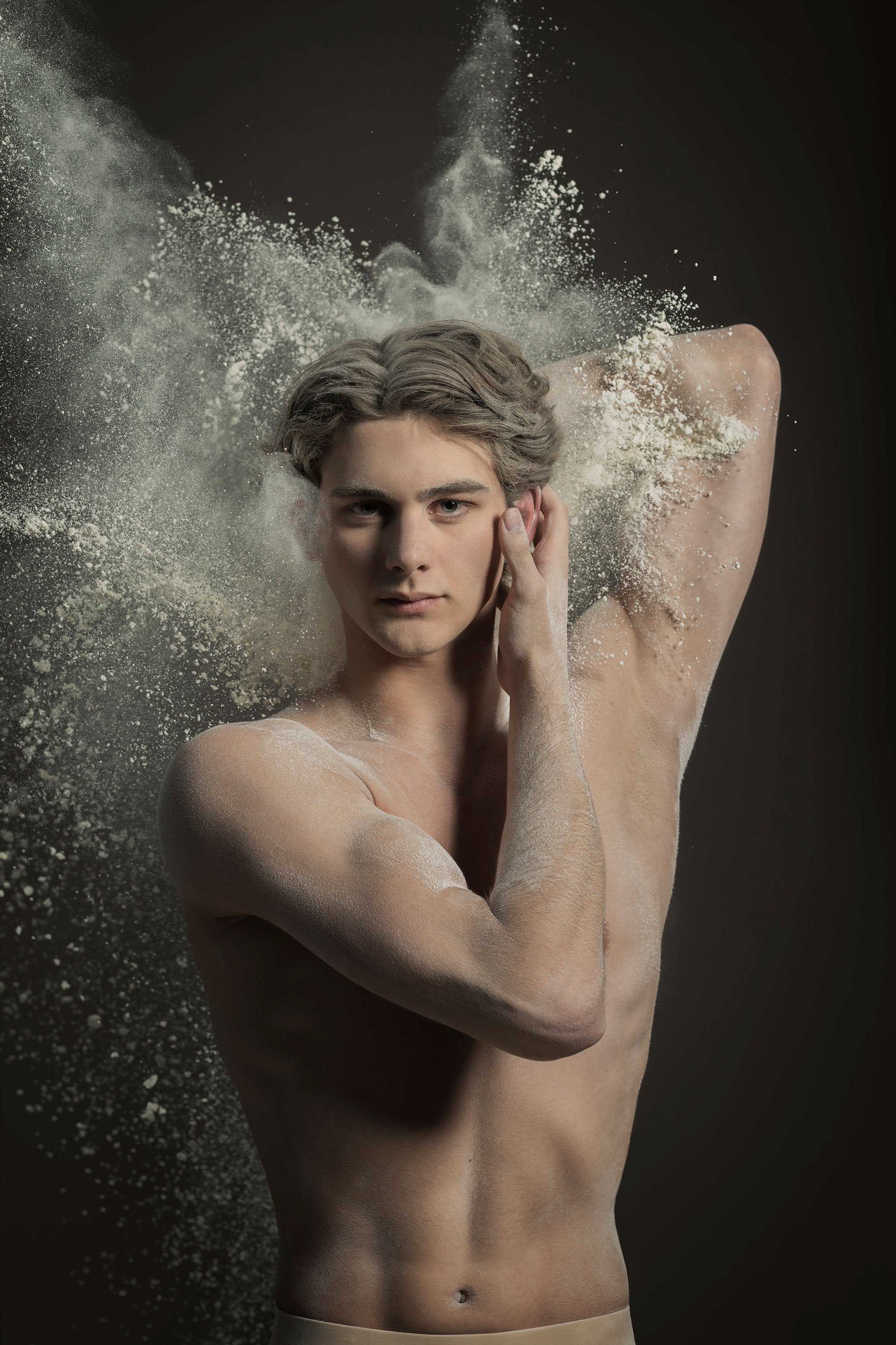 Contemporary dance portrait using powder, movement and dramatic lighting to create a sculptural image of performance and form.