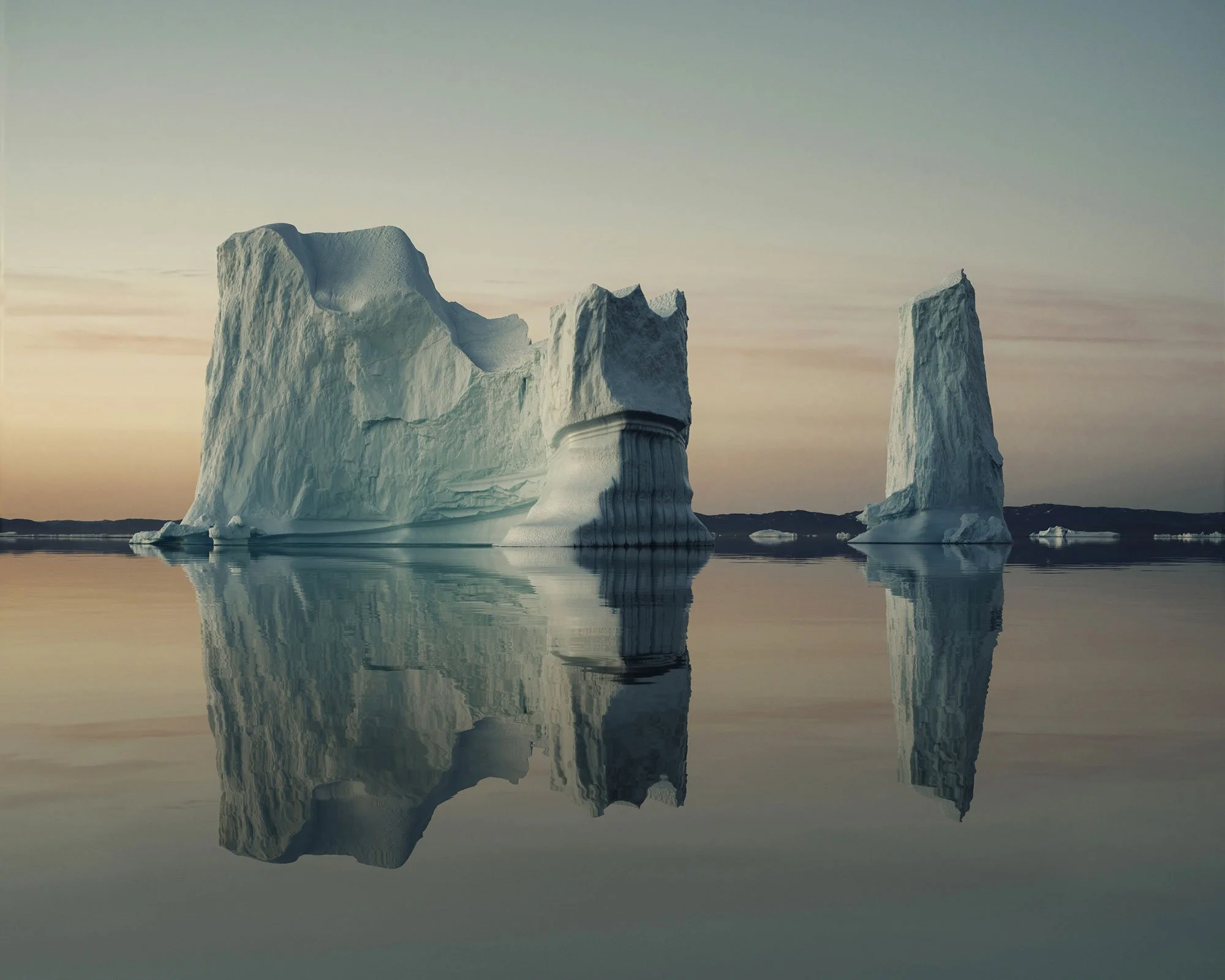 Fine art polar landscape with sculptural ice forms and delicate reflections, photographed in soft pastel light.