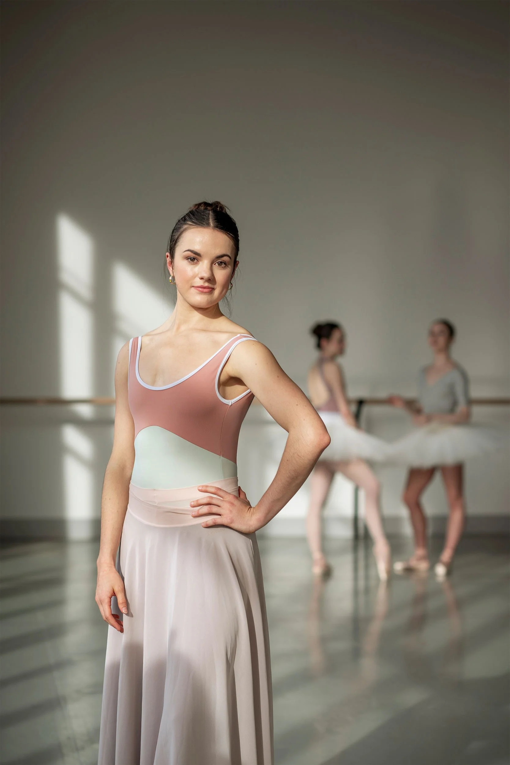 Clean ballet portrait with soft natural light and shallow depth of field, creating a refined image of focus and poise.