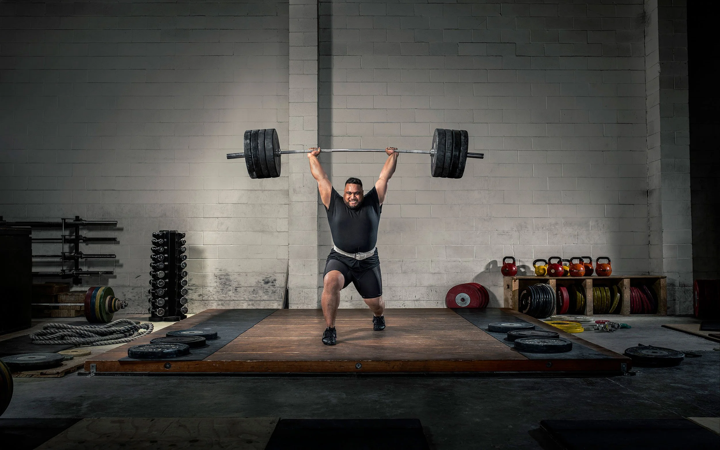Commercial sports photography by Ross Brown, capturing strength, focus and performance in a dramatic gym environment.