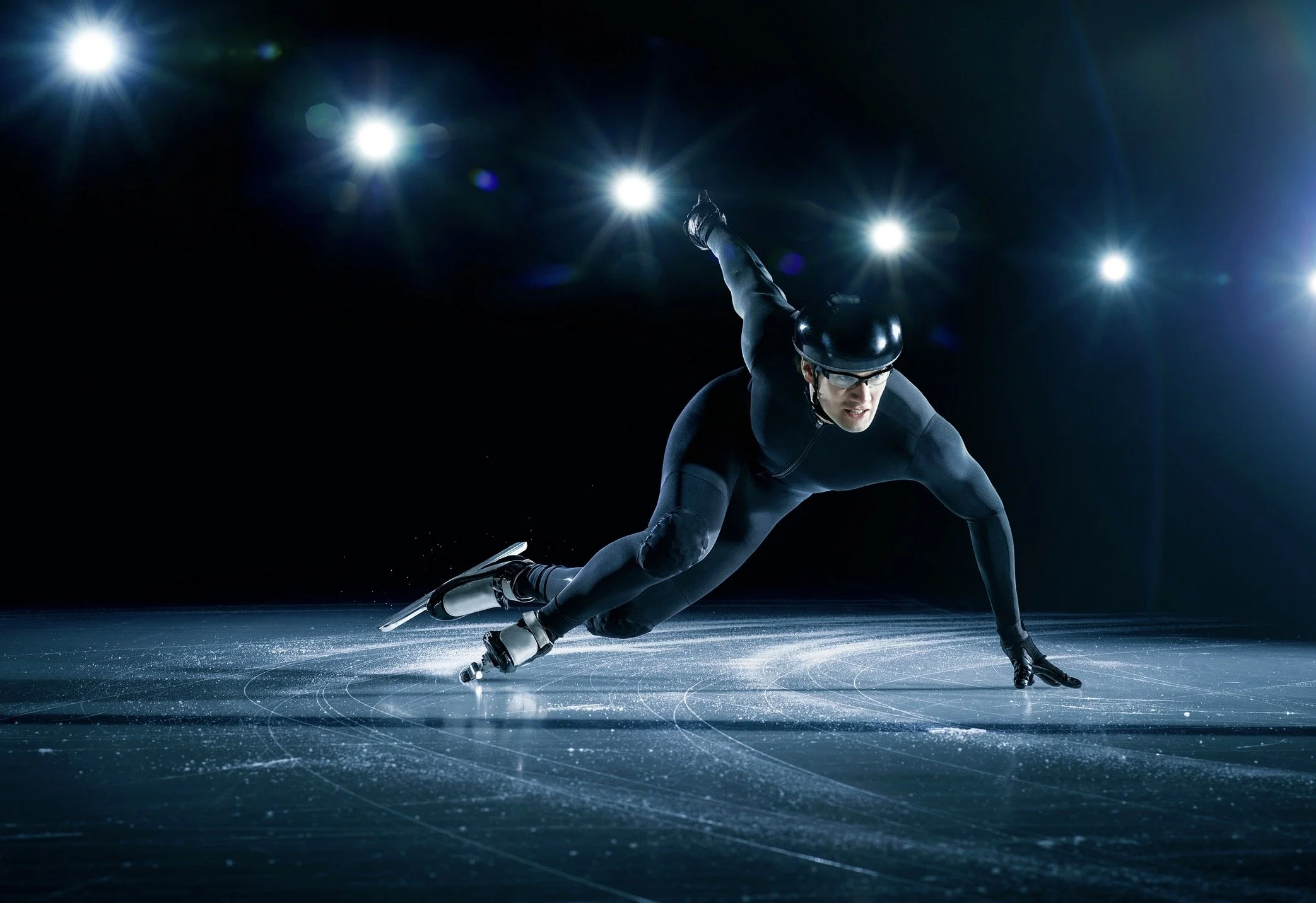 Commercial ice sports photography capturing speed, precision and athletic intensity in a cinematic lighting style.