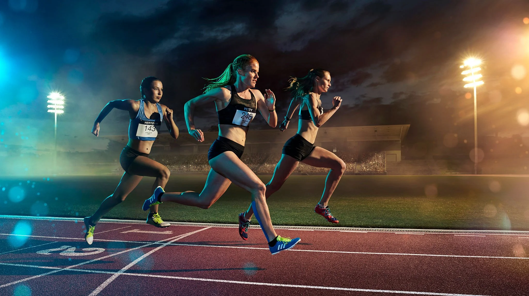 Dynamic athletics photography of runners in competition, using dramatic stadium lighting, movement and cinematic atmosphere.